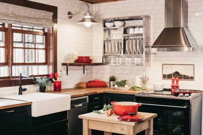 Design reference: kitchen with white tiled walls, a deep apron-front sink, dark lower cabinets, open shelving