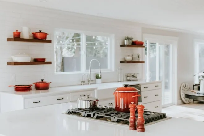 Design reference: bright white kitchen with wood open shelving on either side of a window