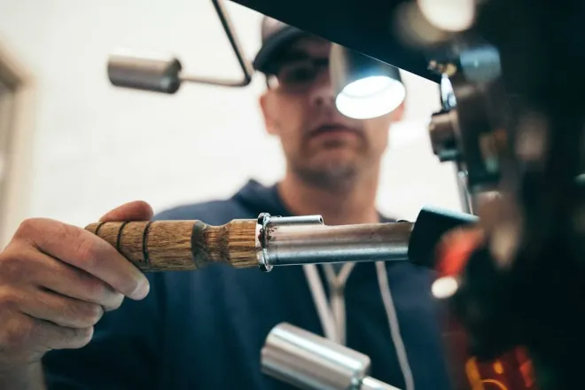 Design reference: a tradesperson in safety glasses working with a hand tool, representing a vetted crew on site