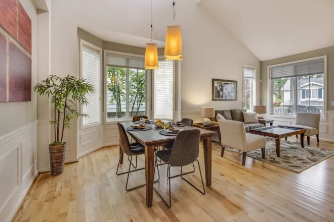 Design reference: dining area in a bay window with a vaulted ceiling, pendant lights