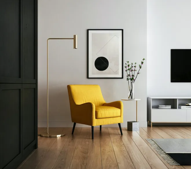 Design reference: hallway with dark panelled doors, light oak flooring, a mustard armchair and a brass wall lamp